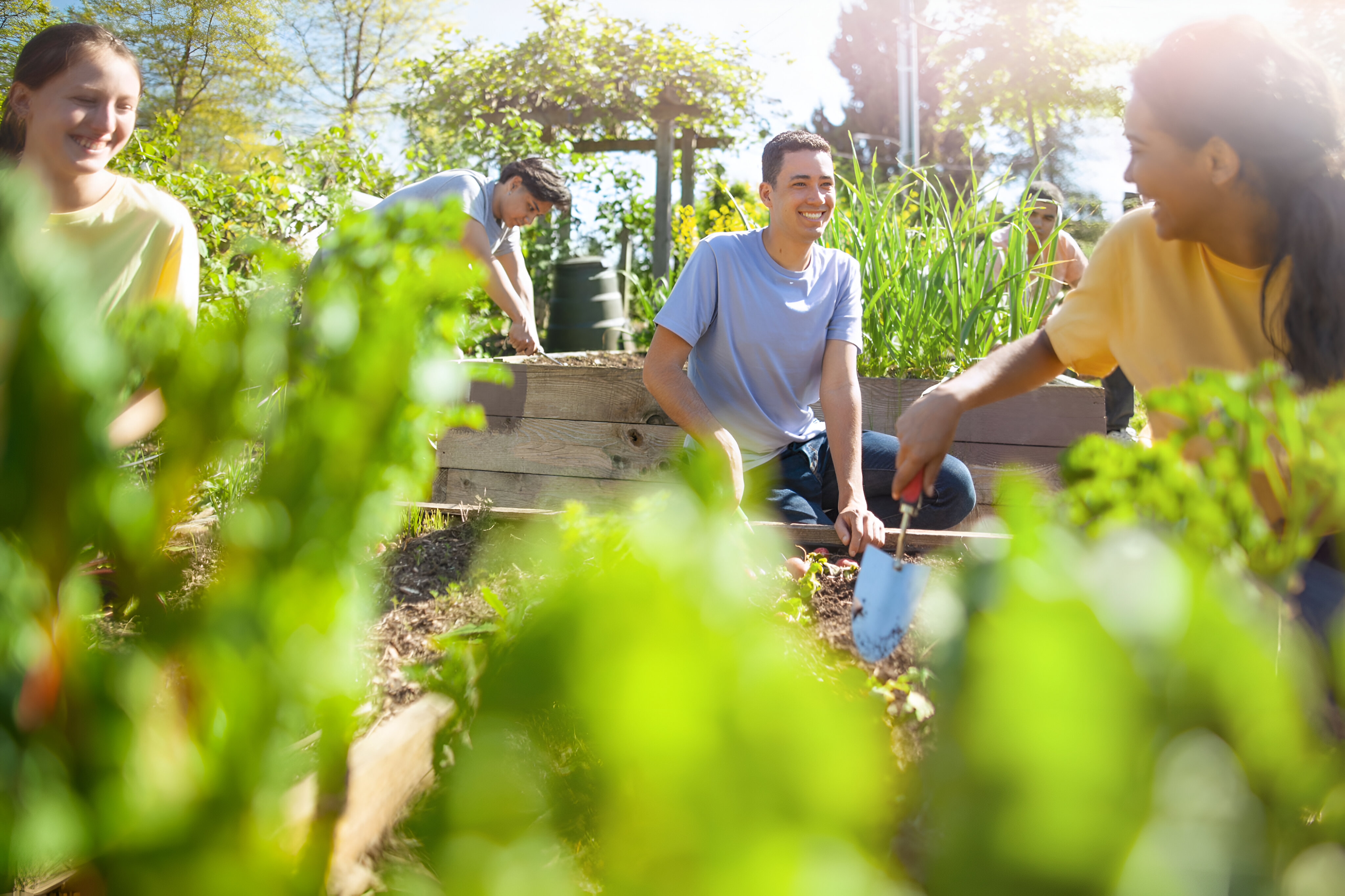 multiracial-group-young-men-young-women-students-plant-together-smiling multiracial-group-young-men-young-women-students-plant-together-smiling