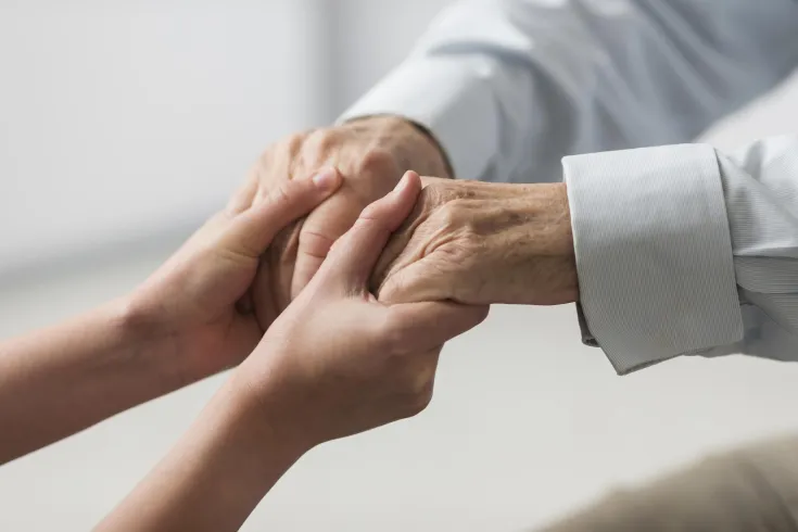 nurse-holding-senior-man-s-hands-sympathy nurse-holding-senior-man-s-hands-sympathy