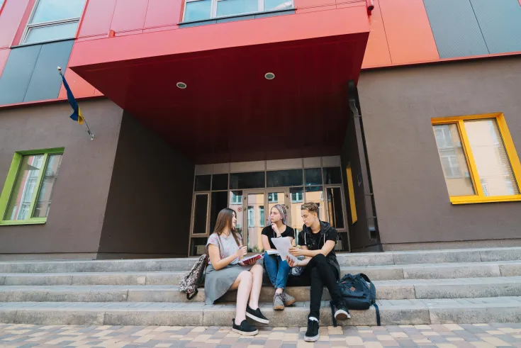 people-posing-entrance-college